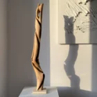 silent-axis-walnut-sculpture-side-opening Side view of Silent Axis abstract walnut wood sculpture with carved opening and travertine stone base