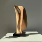 Side view of Veil of Air abstract apple wood sculpture with flowing curved form