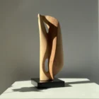 Veil of Air hand carved apple wood sculpture on black beech base in natural sunlight