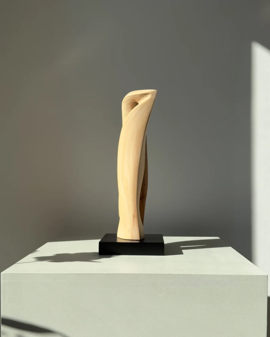 Contemporary apple wood sculpture with organic flowing form