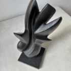 Top view of the abstract apple wood sculpture "Poise", showing the continuous flowing form carved from a single piece of wood.