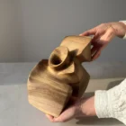 Three-quarter rear view of a hand-carved walnut sculpture.