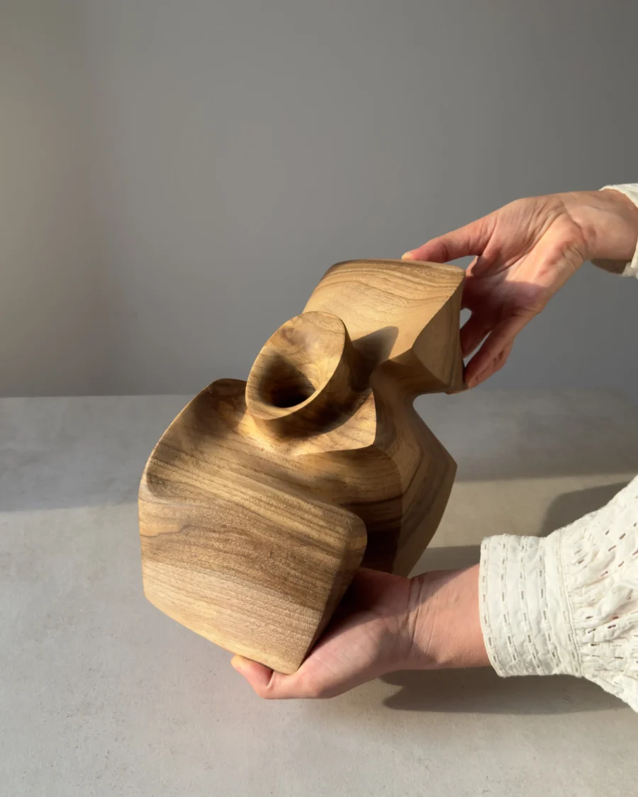 Three-quarter rear view of a hand-carved walnut sculpture.