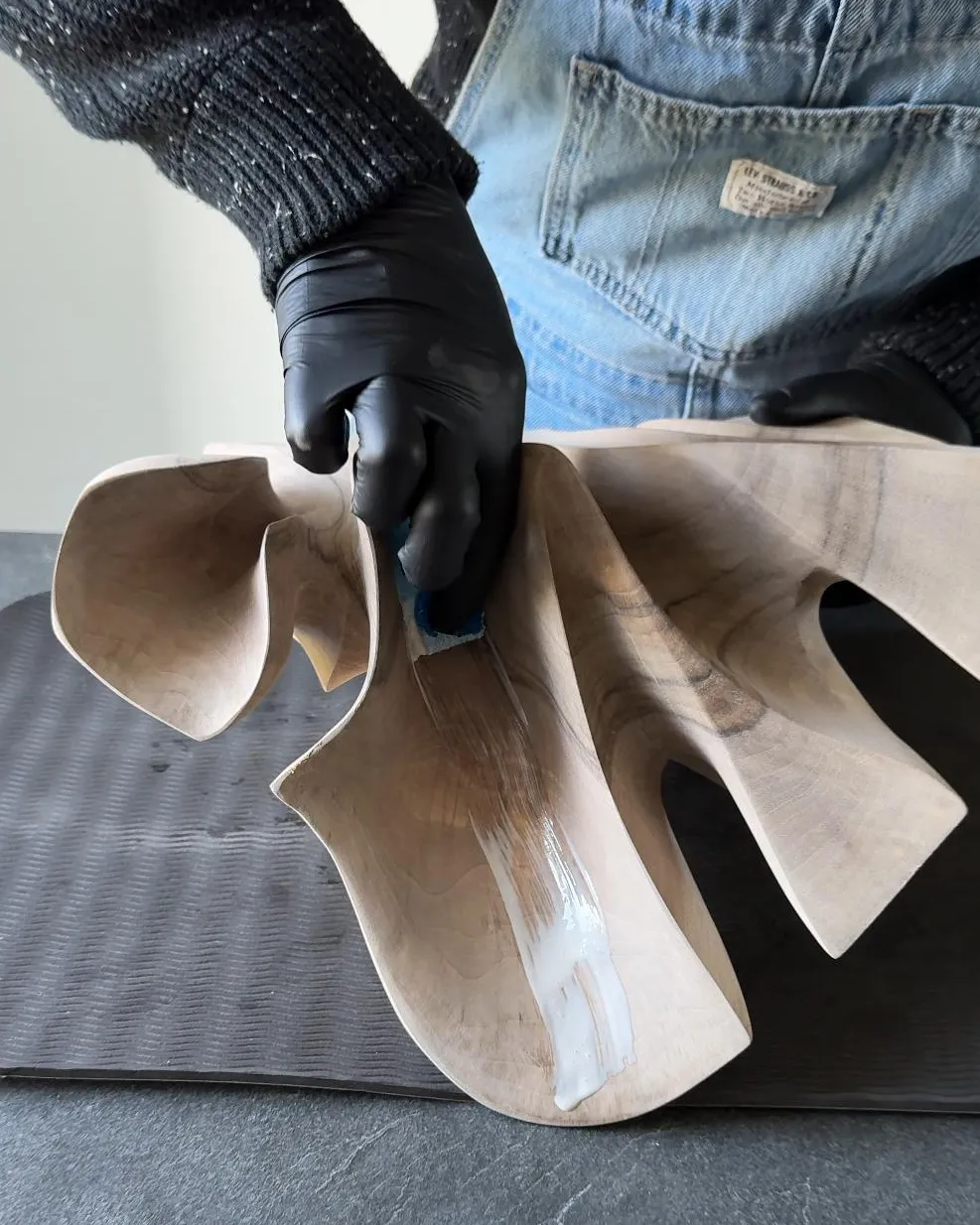 Work in progress on the abstract walnut sculpture Folded Presence.
