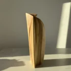 Profile view of Continuum showing its slender architectural silhouette and softly curved outer edge.