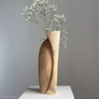 continuum-walnut-vase-fresh-flowers-curved-side Continuum walnut wood sculpture used as a vase with fresh white flowers, showing the broad curved side and asymmetrical top.
