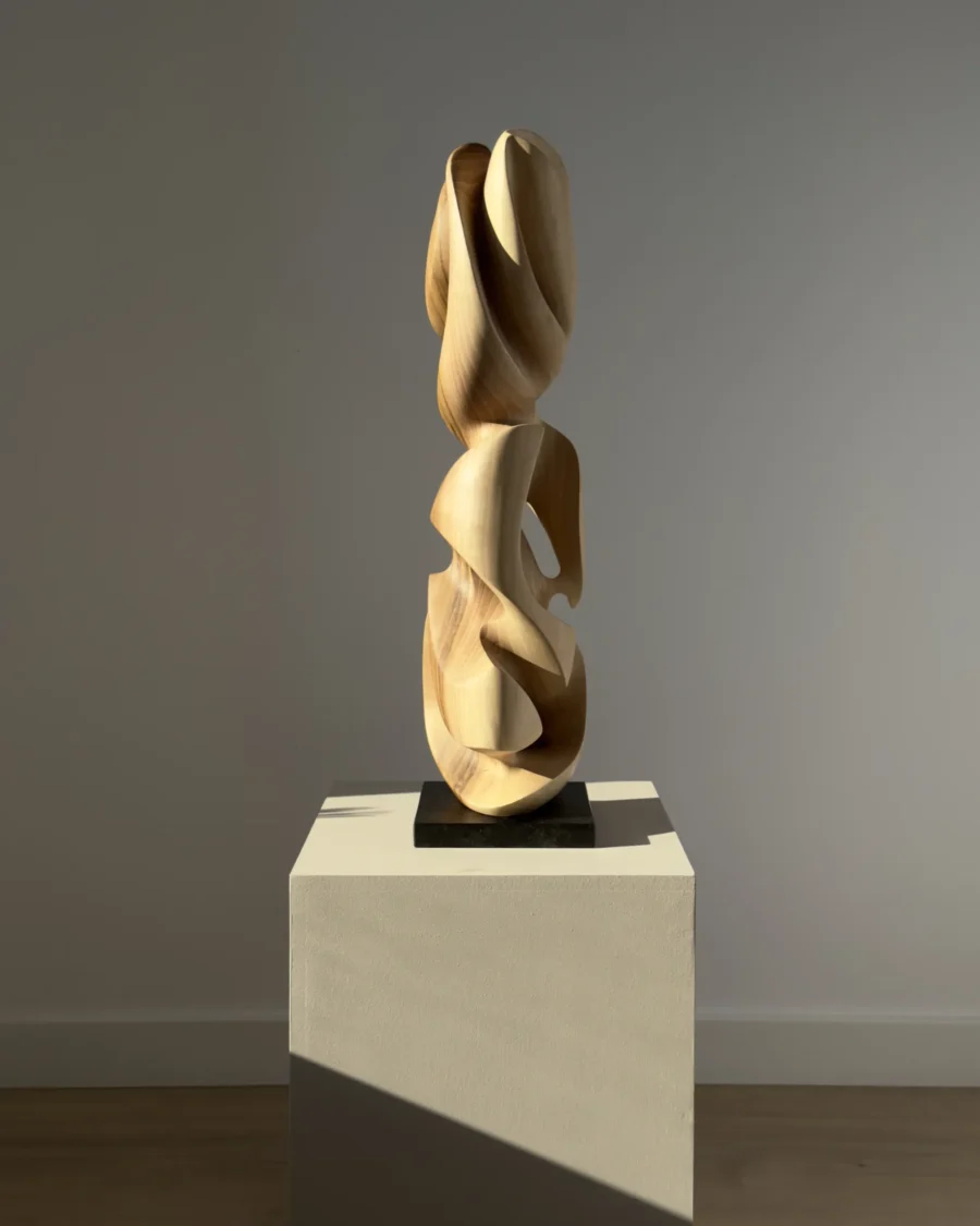 Different perspective of the Convergence sculpture showing the natural contrast of walnut wood.