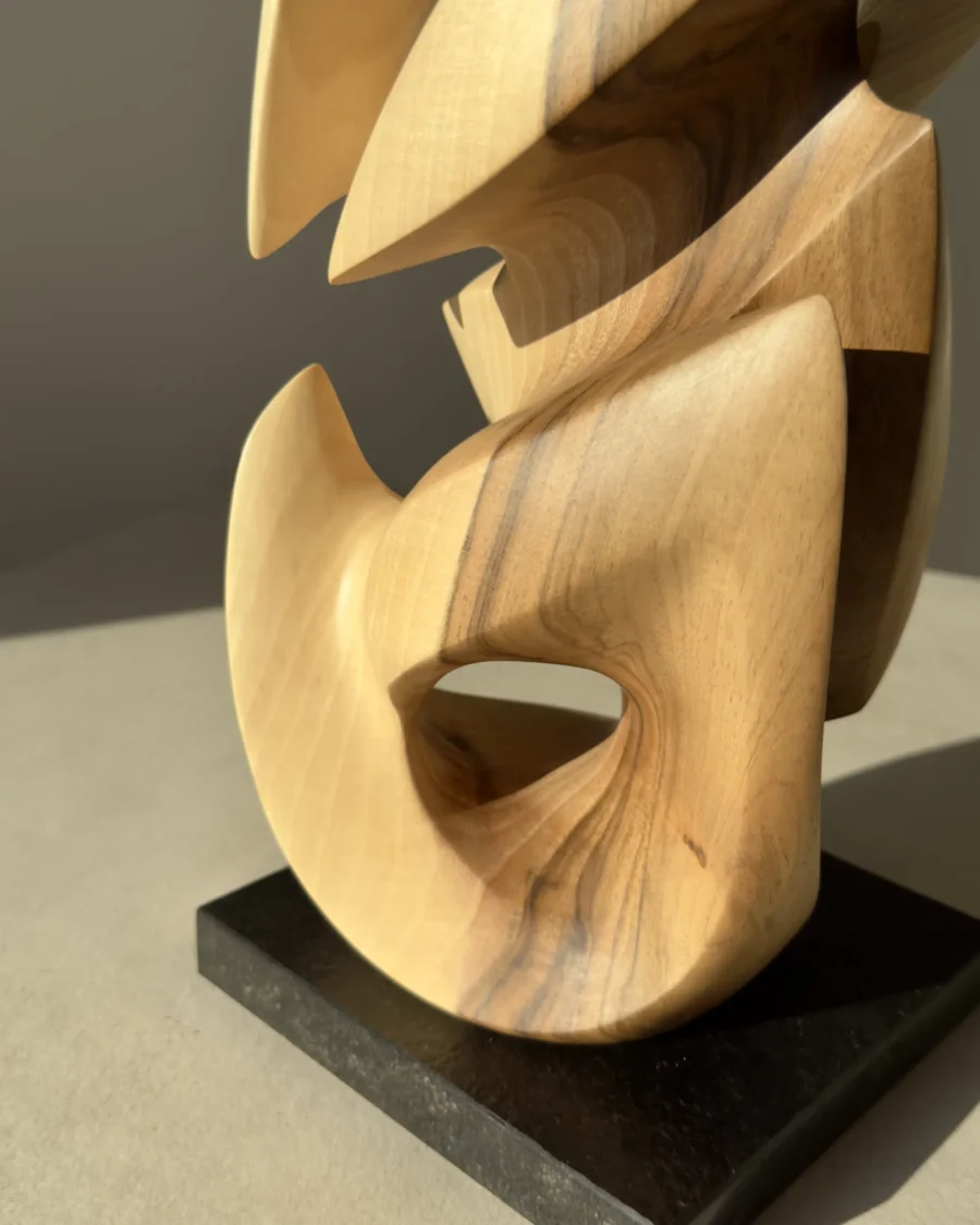 Convergence sculpture mounted on a black granite base.