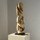 Side view emphasizing the flowing negative spaces carved through the sculpture.