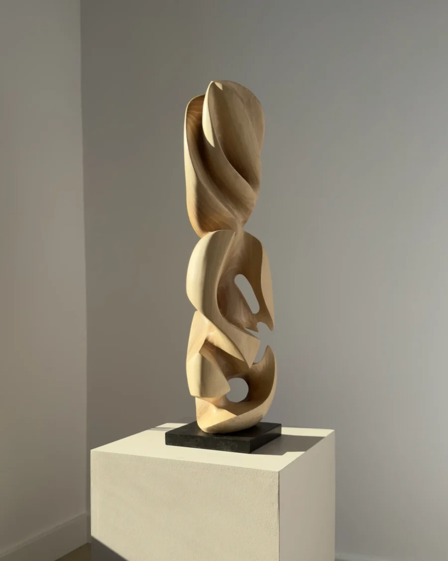 Side view emphasizing the flowing negative spaces carved through the sculpture.