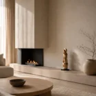 Convergence hand-carved walnut sculpture displayed in a warm Japandi-inspired living room with natural light and a black granite base.