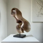 Elaren abstract walnut wood sculpture hand carved from solid European walnut displayed on a polished black granite base.