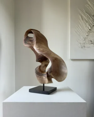 Elaren abstract walnut wood sculpture hand carved from solid European walnut displayed on a polished black granite base.