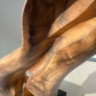 Elaren hand-carved walnut wood sculpture shown in the artist's hands to illustrate scale and handcrafted details.