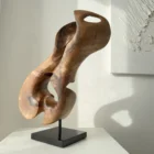 Profile view of Elaren contemporary walnut wood sculpture revealing sculptural curves and the relationship between light and shadow.