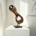 Three-quarter view of Elaren, a hand-carved abstract walnut wood sculpture with flowing organic forms and natural matte finish.