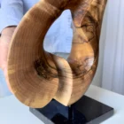Detail of Elaren abstract walnut wood sculpture emphasizing its elegant curves, organic form and natural matte finish.