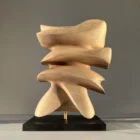 Back view of Fluens highlighting smooth layered planes, flowing silhouette and natural walnut texture.