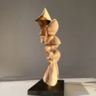 Side profile of Fluens revealing sculptural depth, flowing contours and the natural walnut grain.