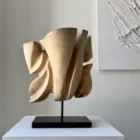 Rear view of Folded Presence revealing layered planes and changing light across the hand-carved walnut surface.