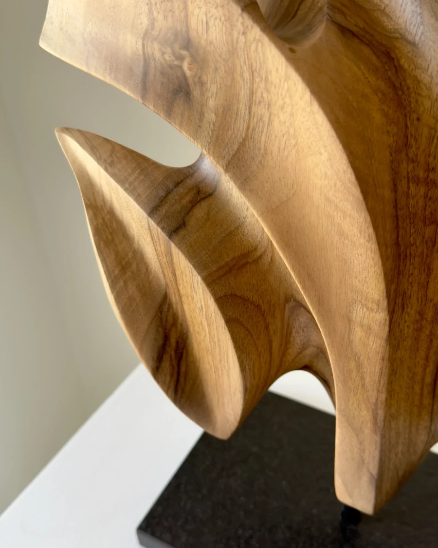Detail of Folded Presence showing flowing carved surfaces, natural walnut grain and sculptural folds.