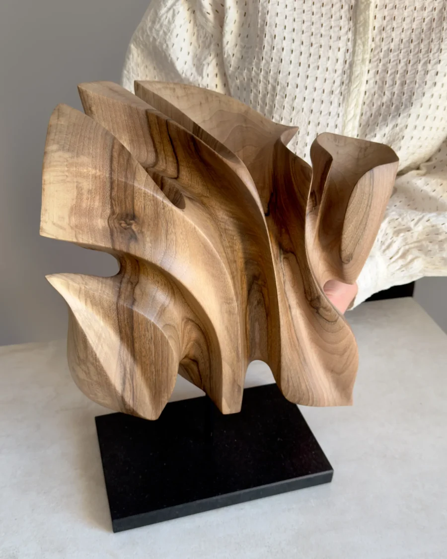 Different view of Folded Presence, a one-of-a-kind hand-carved walnut wood sculpture that changes with every angle.