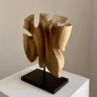 Right-side view of Folded Presence showing folded organic forms carved from a single piece of walnut wood.