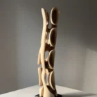 Rear view of Ivory Flow showing the relationship between carved openings, grain and natural walnut tones.