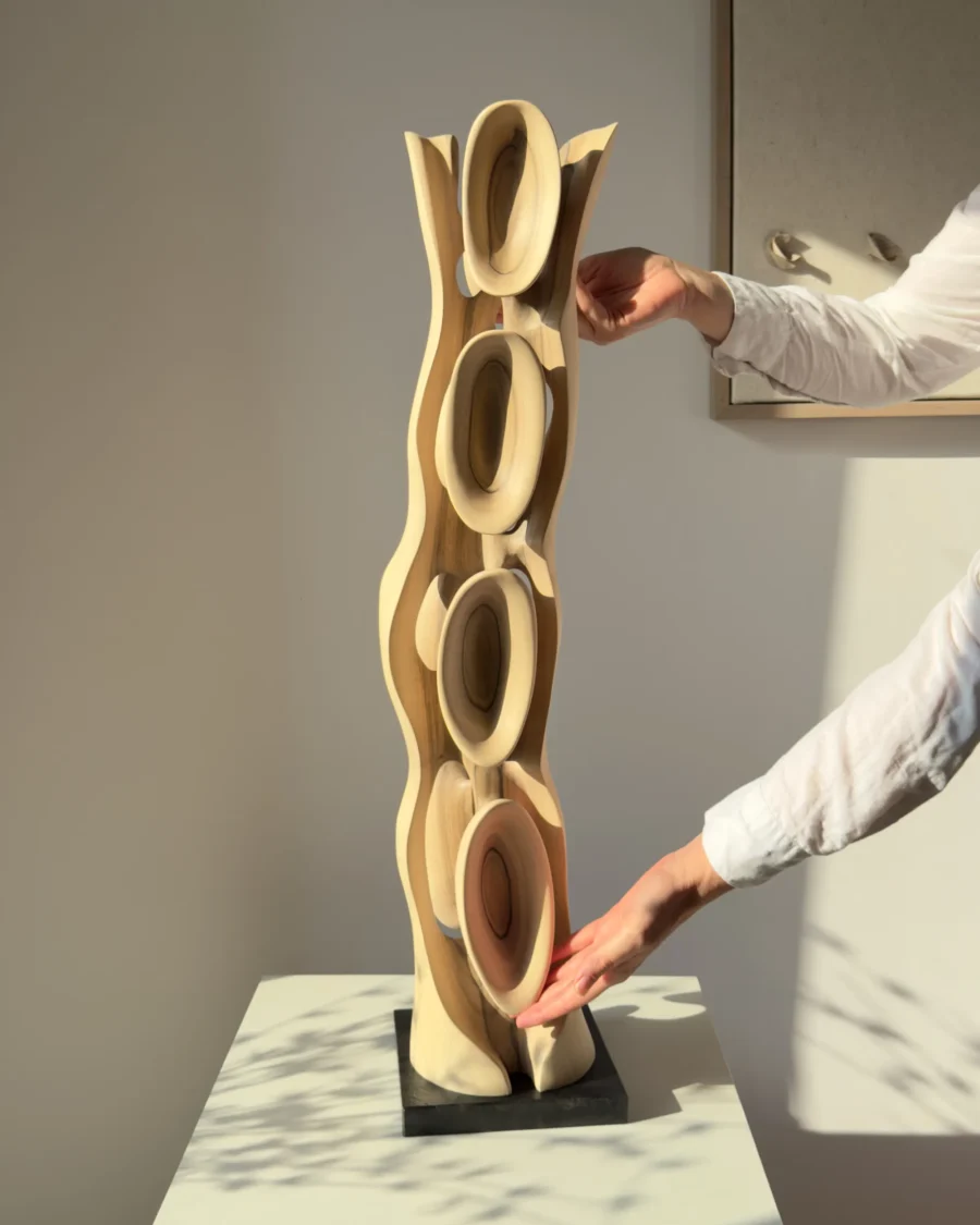Ivory Flow abstract walnut sculpture shown with hands to illustrate its scale and handcrafted details.