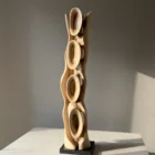 Ivory Flow contemporary walnut sculpture with changing light and shadow across its organic carved forms.