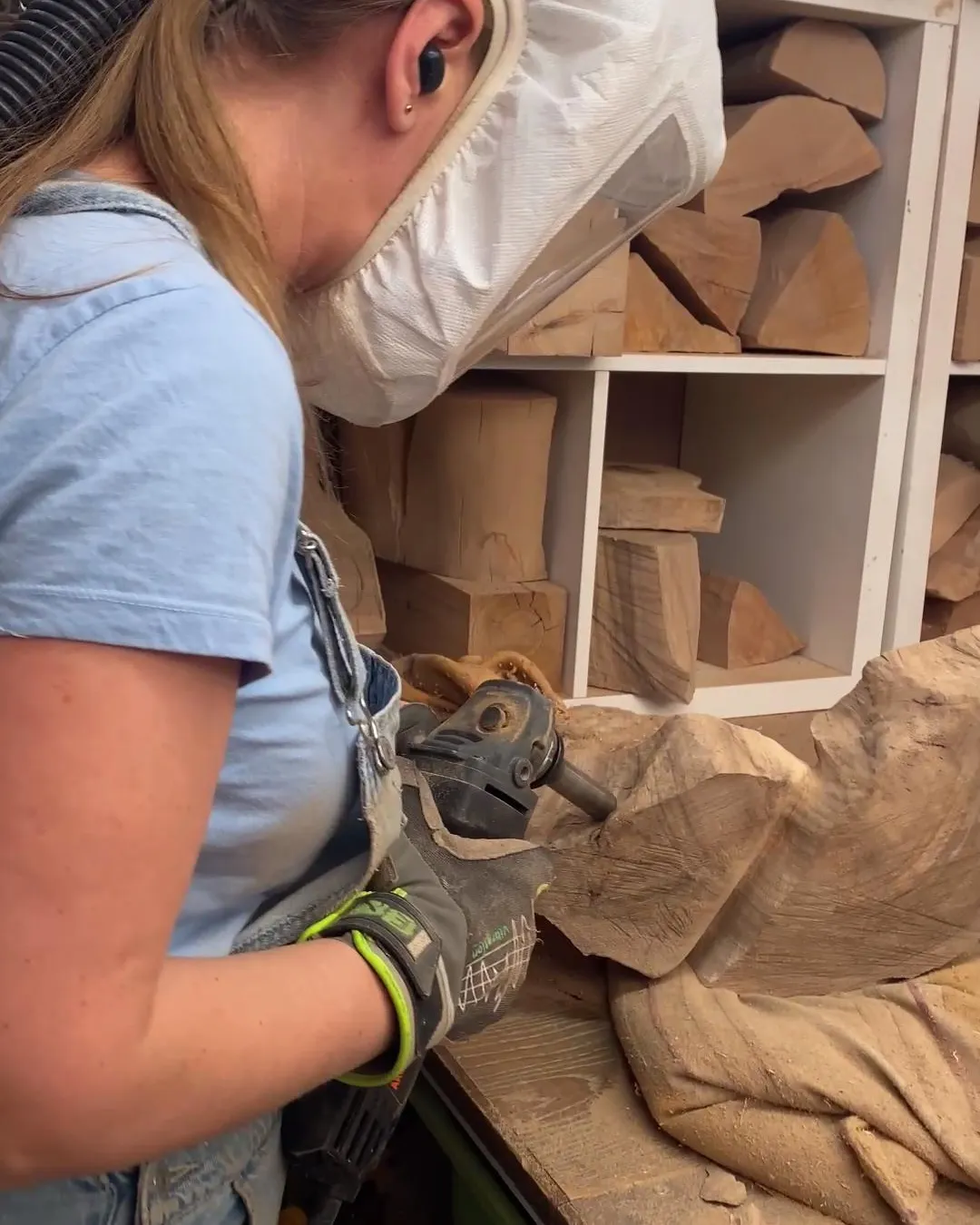 Holding the unfinished walnut sculpture Confluence while evaluating its evolving form.