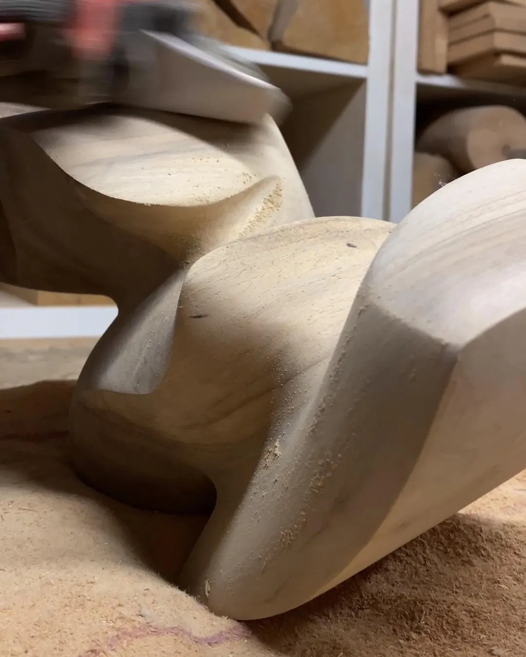 Close-up of the unfinished walnut sculpture Confluence during shaping, capturing a moment before the next carving decision.