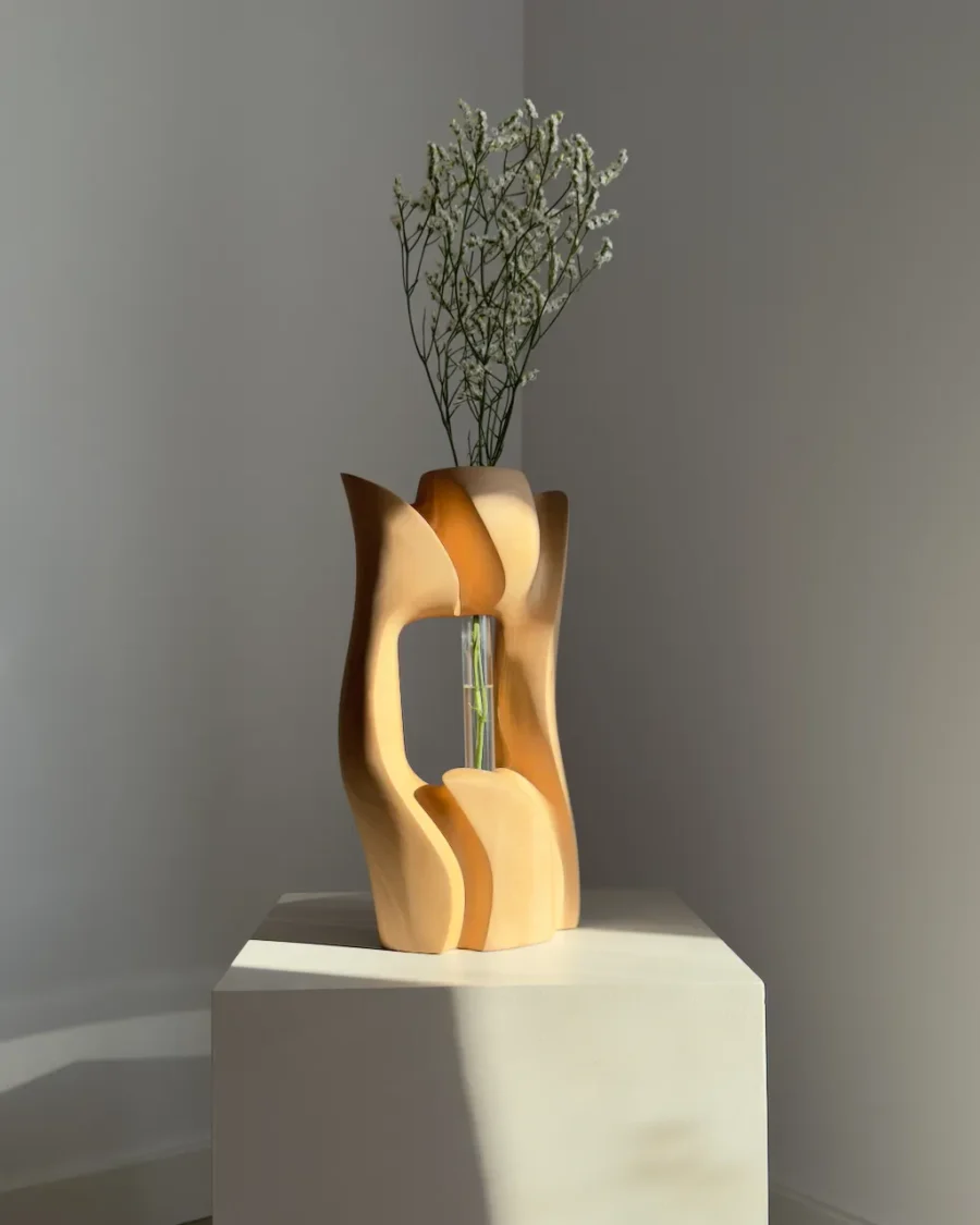 Rear view of Lumen hand-carved pear wood vase with white flowers, showing its open sculptural form.