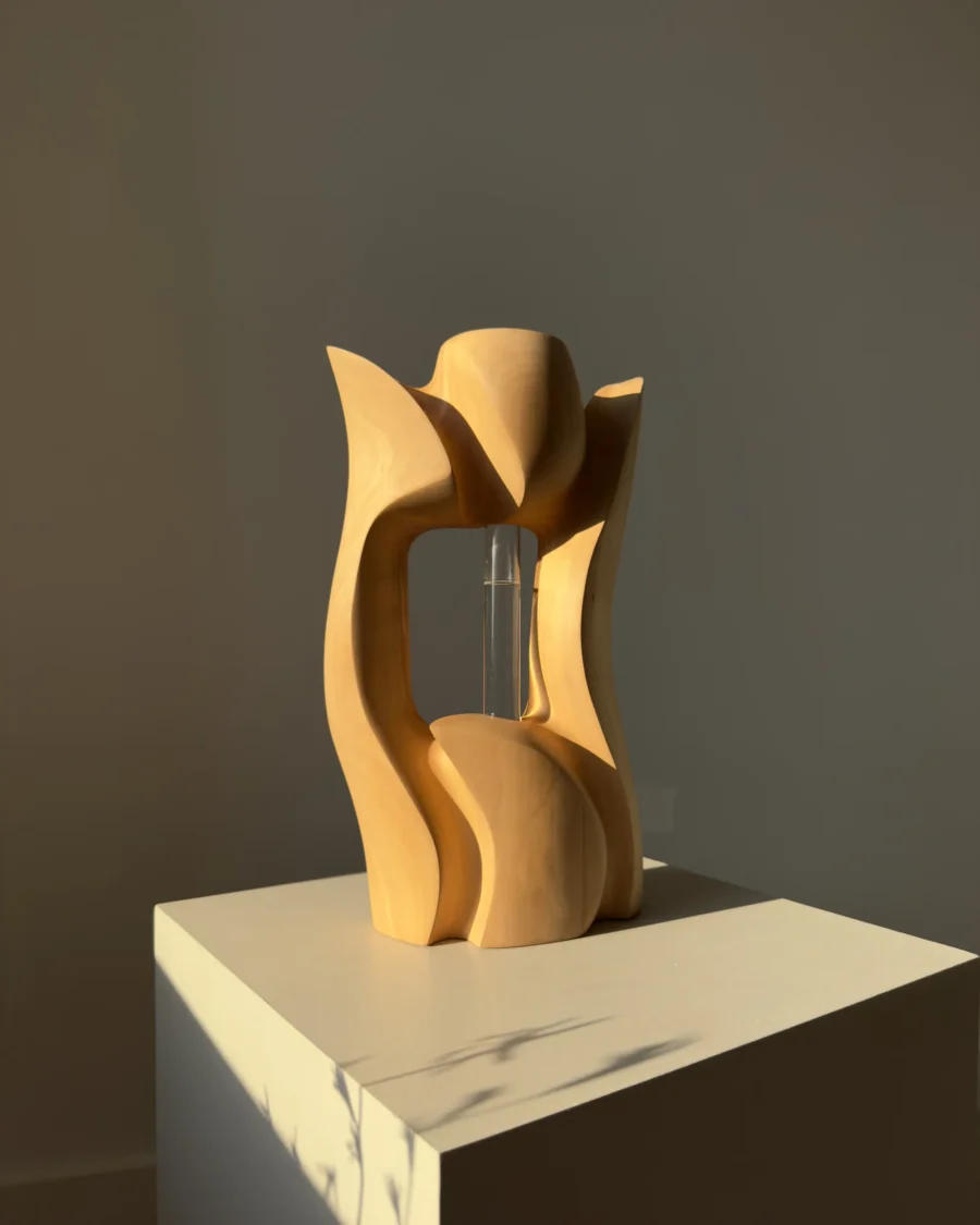 Back view of Lumen, a hand-carved pear wood sculptural vase with an open central space.