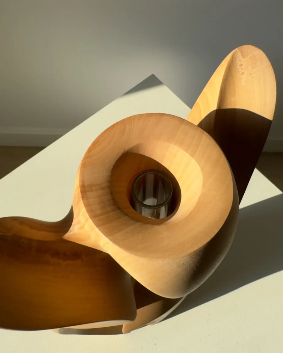 Top opening detail of Lumen showing the carved cavity and removable glass tube inside solid pear wood.