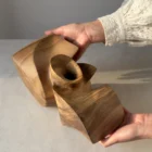 Abstract walnut sculpture photographed in natural light highlighting the changing tones of walnut.