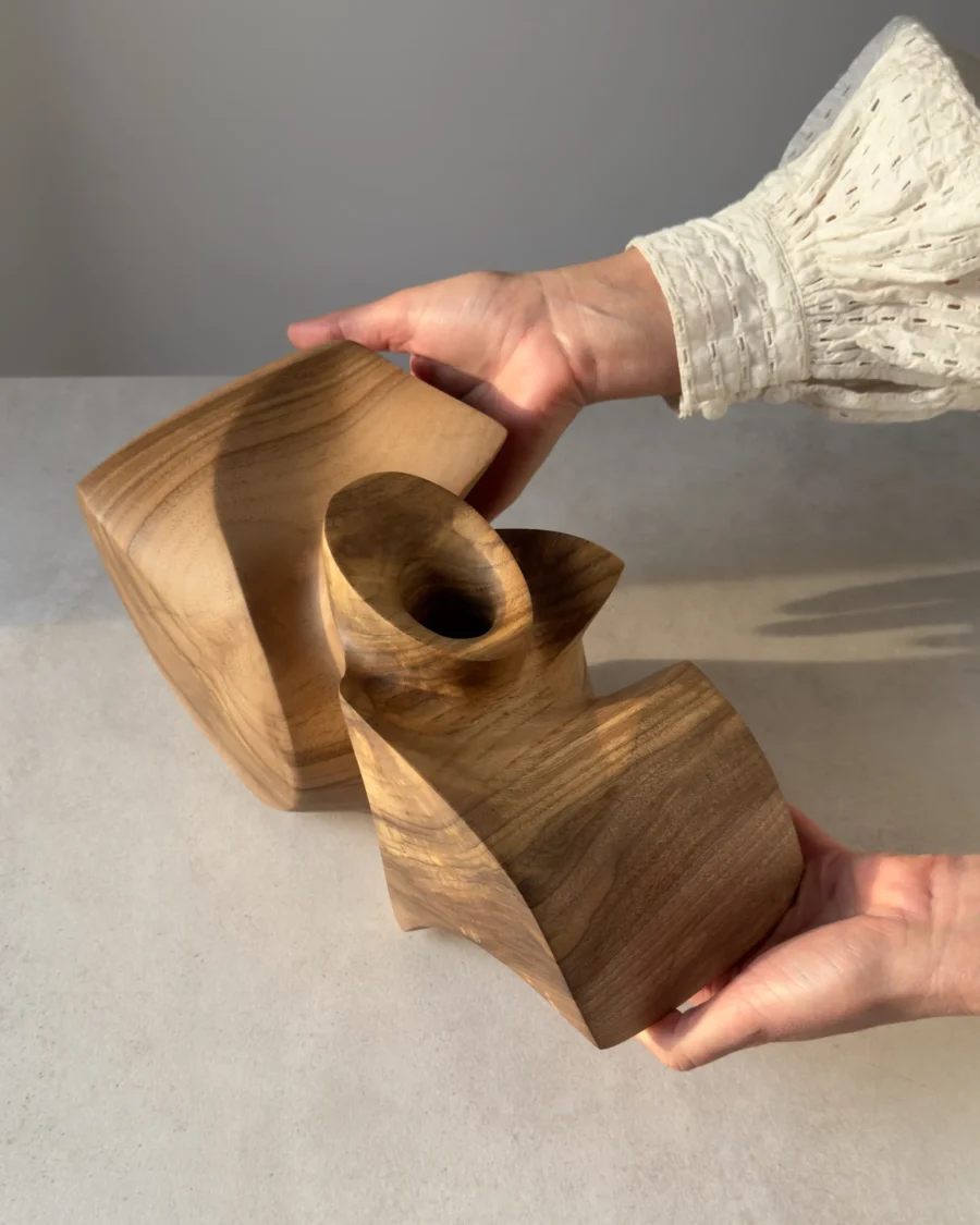 Abstract walnut sculpture photographed in natural light highlighting the changing tones of walnut.