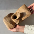 Top view of an abstract walnut sculpture showing the sculptural flared opening.