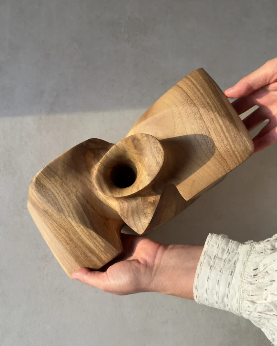 Top view of an abstract walnut sculpture showing the sculptural flared opening.