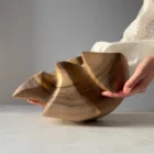 Bottom view showing the solid walnut construction of the sculpture.