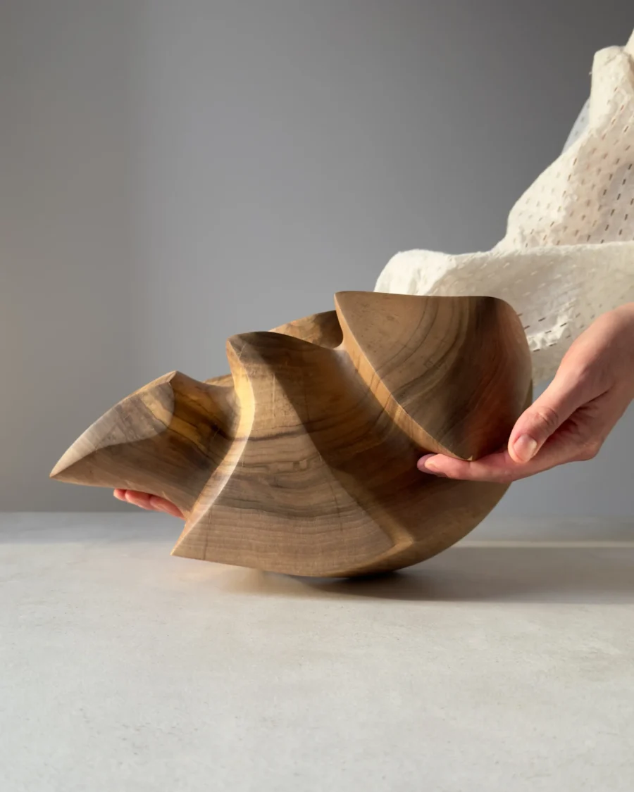 Bottom view showing the solid walnut construction of the sculpture.