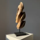 Perspective view of Silent Ascent hand-carved walnut wood sculpture highlighting its flowing vertical form.