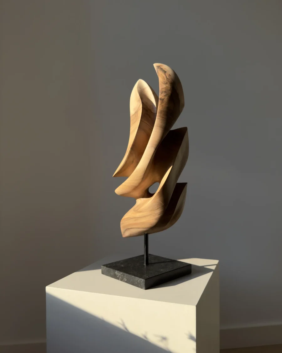 Profile view of Silent Ascent contemporary walnut sculpture showing organic curves and changing light.