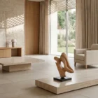 Sway hand-carved abstract apple wood sculpture displayed in a bright Japandi-inspired interior with natural stone, oak and soft daylight.