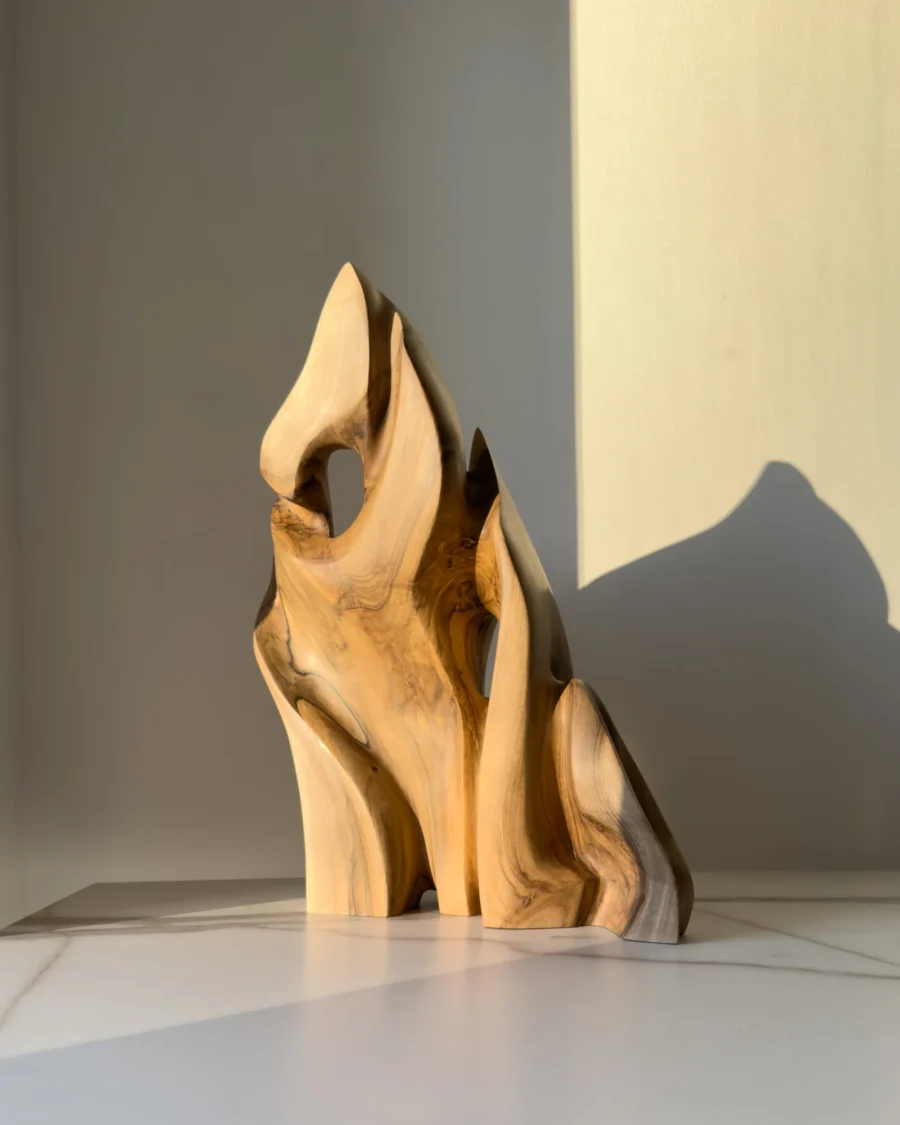 Hand carved walnut wood sculpture Together as One showing flowing biomorphic forms and natural walnut grain.