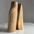 Twin Presence hand-carved sculptural walnut vase viewed from the front in natural light.