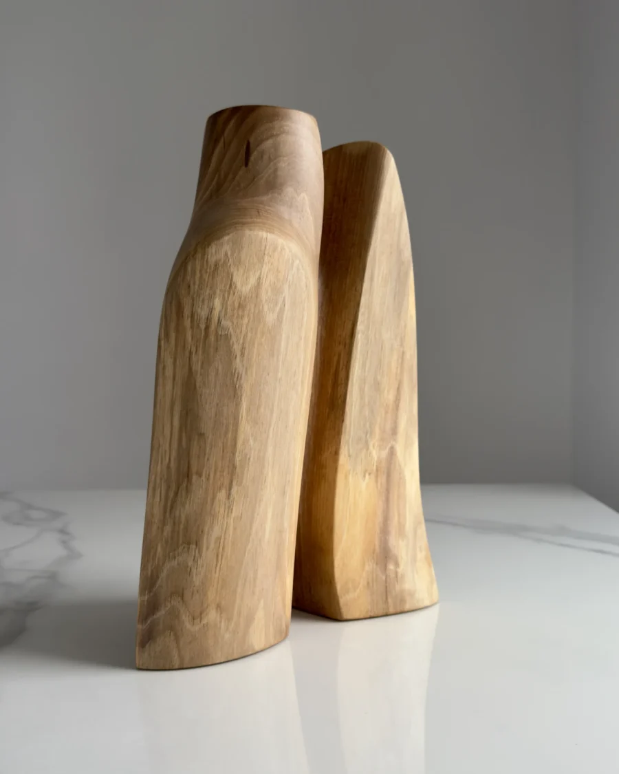 Twin Presence hand-carved sculptural walnut vase viewed from the front in natural light.