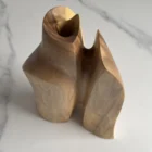 Top view of Twin Presence showing the sculptural opening and removable glass insert for fresh flowers.