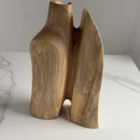 Three-quarter view of Twin Presence, a one-of-a-kind sculptural walnut vase with two organic forms.