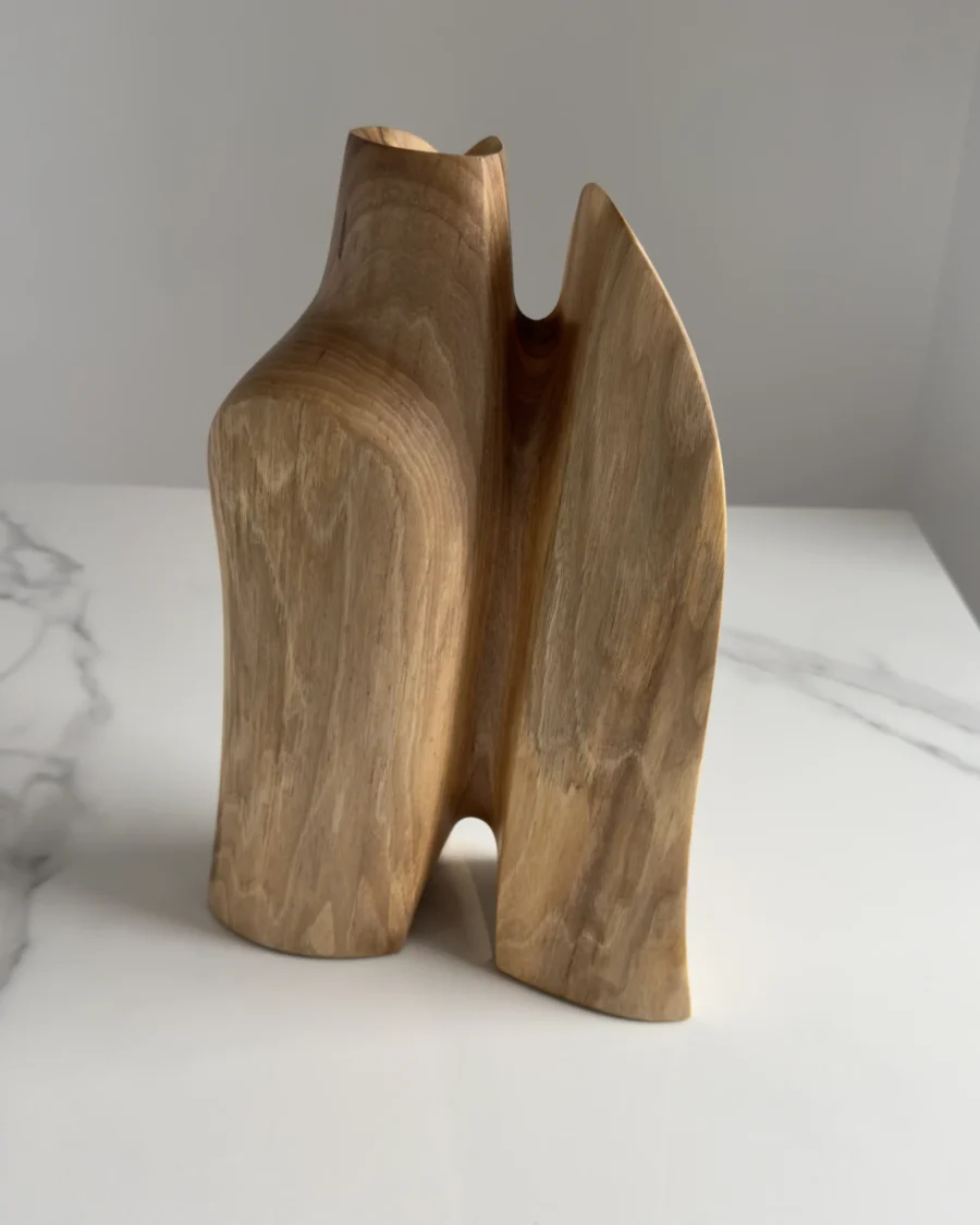 Three-quarter view of Twin Presence, a one-of-a-kind sculptural walnut vase with two organic forms.